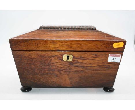 A Regency rosewood twin compartment tea caddy, of sarcophagus form, standing on four bun feet, 28cm wide