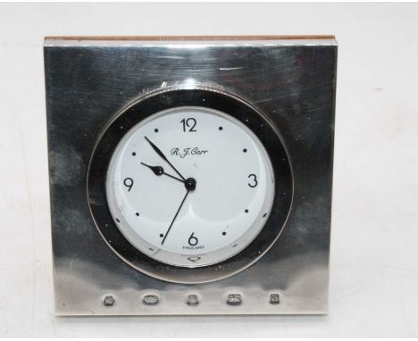 A modern Carr's silver clad easel mantel clock, having a circular dial with Arabic quarter hour markers, 10 x 10cm 