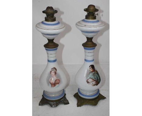 A pair of early 20th century opalescent glass oil lamps, each transfer printed with a portrait of Napoleon and Josephine, on 