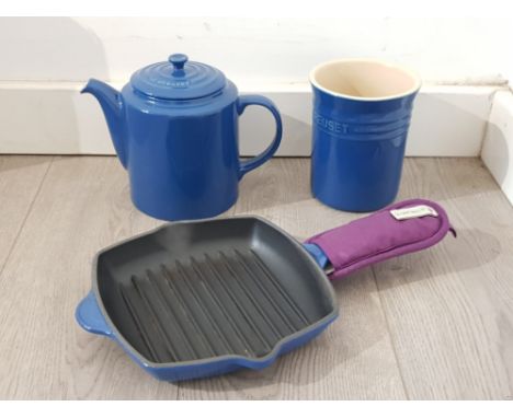 Small le creuset cast iron skillet, and a ceramic teapot and utensil holder by the same maker.