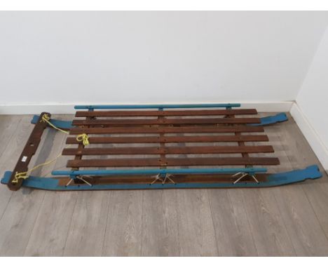 A facsinating and rare WWII sled on original runners painted original blue and crafted for allied expedition in which the sle