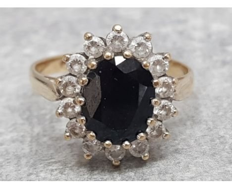 Ladies 9ct yellow gold sapphire and cubic zirconia cluster ring, comprising of a black sapphire in the centre surrounded by 1