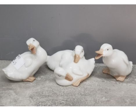Three Nao white duck figurines and group.