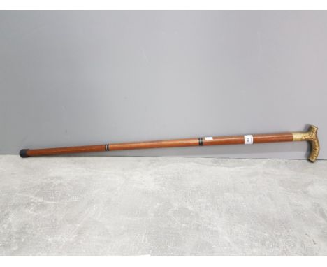 A brass and wooden walking stick.