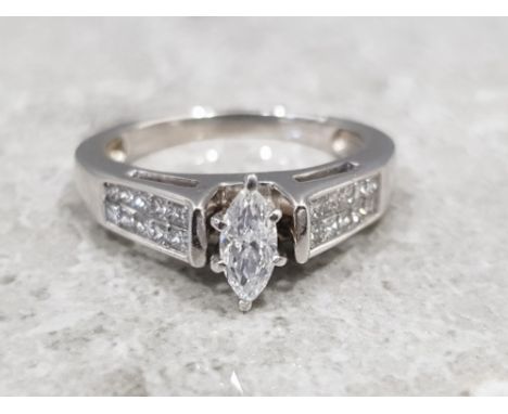 Ladies 14ct white gold diamond ring, featuring a marquise cut diamond in the centre with 10 princess cut diamonds. Tension se