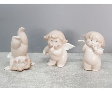 Three Nao cherubs, one doing a handstand.