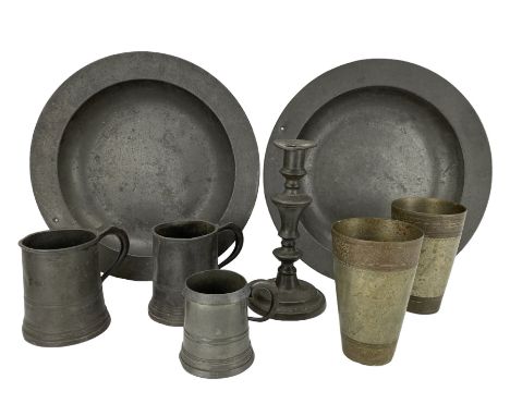 Two 18th century pewter bowls, both bearing London touchmarks, D33.5cm, three pewter measures, pewter candlestick with knoppe