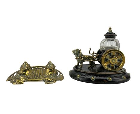 19th century novelty brass and ebonised inkwell modelled as a lion towing a cart, with faceted glass inkwell on oval base L20