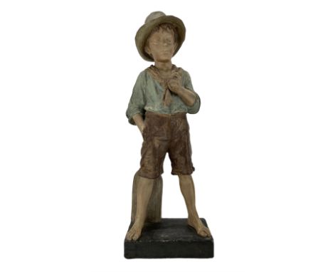 J. Mercadier for Goldscheider, large terracotta figure of a young boy standing barefoot by a sign, on rectangular base signed