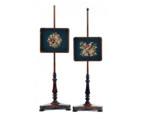 A PAIR OF VICTORIAN ROSEWOOD POLE SCREENS, C1840  with contemporary woolwork banner of a bird on a branch or flowers, bun fee