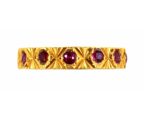 A SYNTHETIC RUBY ETERNITY RING IN 18CT GOLD, 4.9G