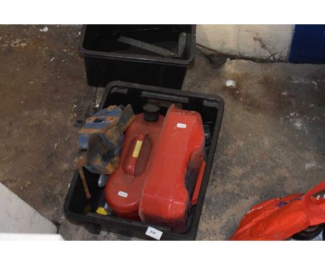 Box of fuel cans and a bench vice