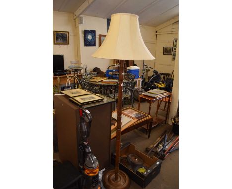 A turned wood standard lamp and shade