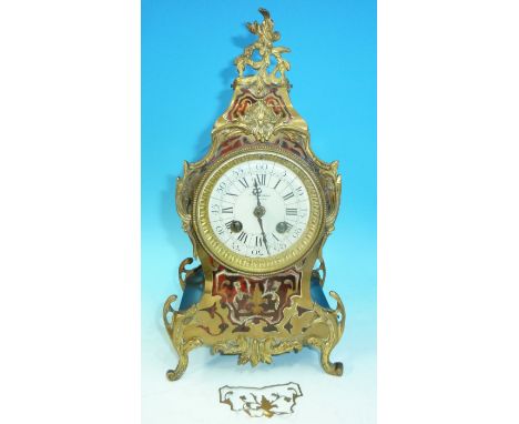 A 19th century French ormolu and boulle mantel clock with rococo mounts and feet, white enamel dial, and 8 day French strikin