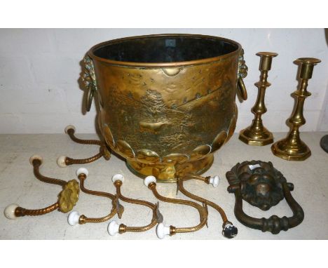 A large brass plant holder; an open barley twist brass table lamp; a pair of brass candlesticks; a face mask door knocker; a 