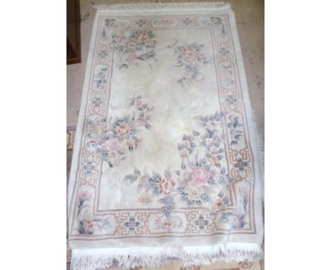 A Chinese fawn ground floral pattern carpet, 76" x 48"