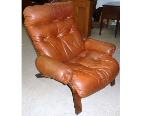 A 1960's armchair with tan leather cushions on leather and canvas laced support, by Rykken &amp; Co, Norway, stamped with mak