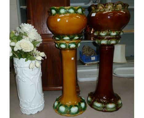 A pair of Victorian style brown glazed jardinières on stands; a modern white ceramic stick stand