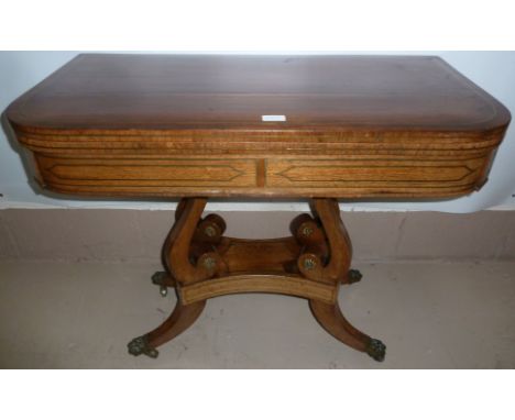 A Regency period rosewood rectangular fold-over baize lined card table with brass inlay, on 4 scroll columns, 4 splay feet te