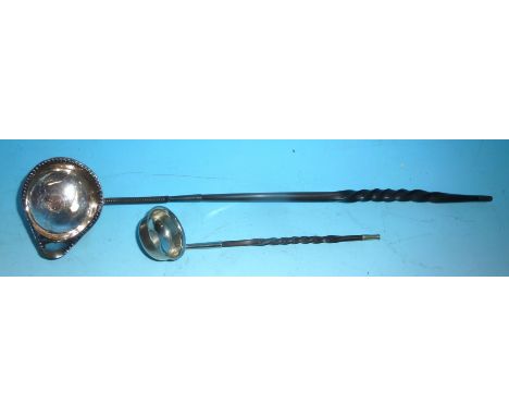 An 18th century continental silver punch ladle with inset gold coin "Ioan V", beaded lipped rim with whalebone handle; a simi