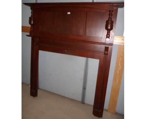 A 1930's oak fire surround with columns and 2 shelves, height 64"