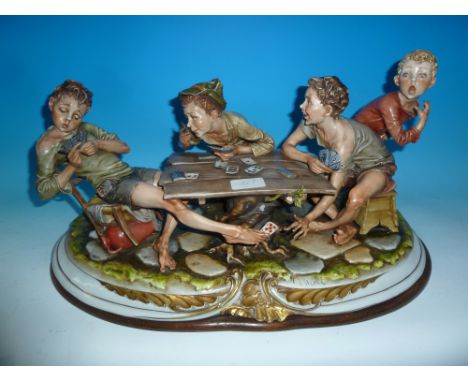A large Capodimonte group:  boys playing cards, length 22" (crack to rear)