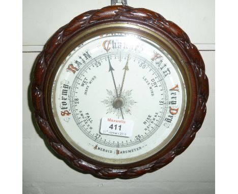 An Edwardian oak aneroid barometer in rope twist case