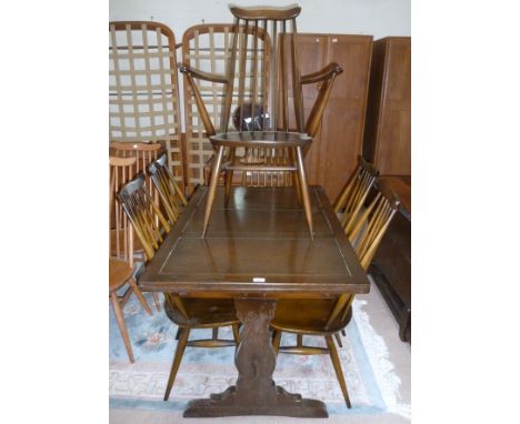 An Ercol dining suite comprising oak draw leaf refectory table and 6 (4 + 2) high stick back dining chairs