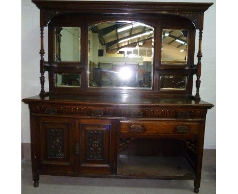 A late 19th century carved oak mirror back sideboard, the mirror back with moulded and dentil cornice, turned side pillars an