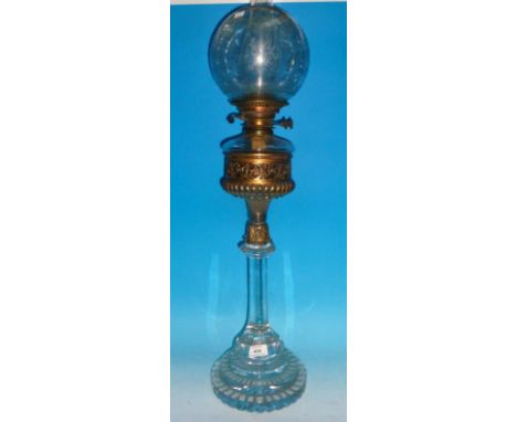 A Victorian faceted glass oil lamp with stepped base, octagonal column, brass reservoir and etch shade