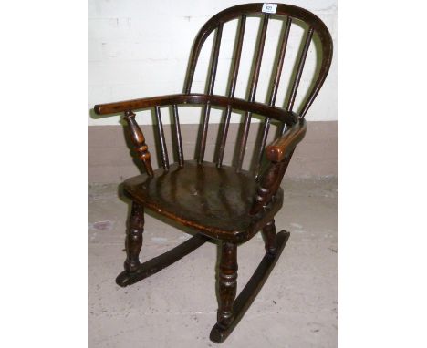 A 19th century child's hoop and stick elm Windsor rocking armchair