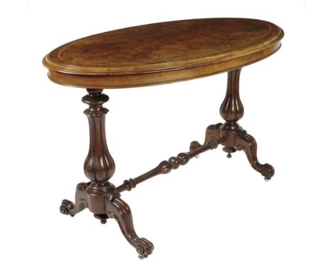  A Victorian walnut oval centre table, the burr veneered top with a mouded edge and kingwood banding, on lobed baluster suppo