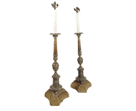  A pair of 18th century Italian painted and carved wood altar candlesticks, each with a lappet and foliate decorated stem, on