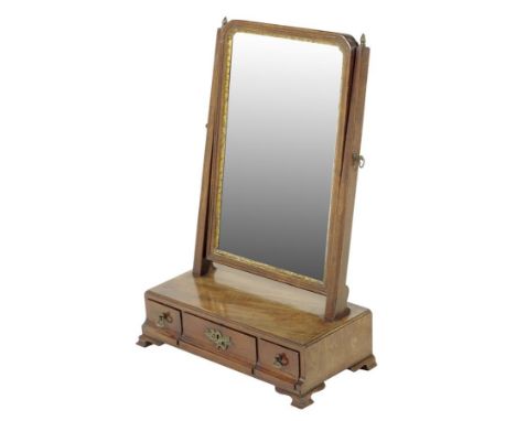  A George II walnut dressing table mirror, the arched plate within a carved giltwood slip and a moulded frame, the box base w
