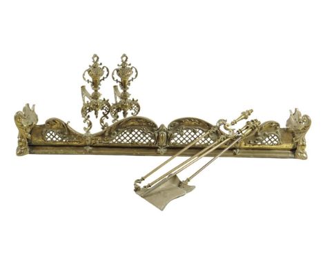  A late 19th century gilt brass fire compendium, comprising: a fender, a pair of andirons and a set of three fire tools, the 