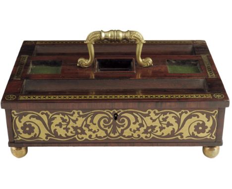 λ A George IV rosewood and brass marquetry desk stand, with a cast foliate brass handle above a lidded compartment flanked by