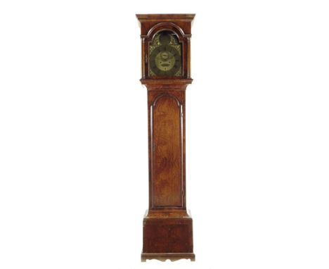  A walnut longcase clock, the eight day movement striking on a bell, the twelve inch arched dial with Roman numerals and cast