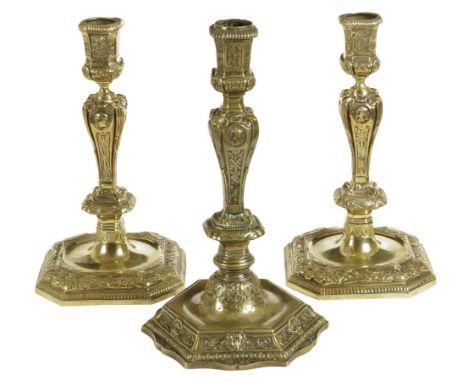  A pair of 18th century French brass candlesticks, the tapering bodies decorated with relief portrait busts, each on an octag