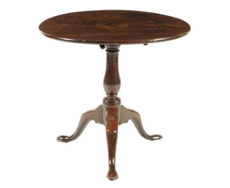  A George II mahogany tripod table, the circular tilt-top above a baluster stem, 64.4cm high, 70cm diameter.