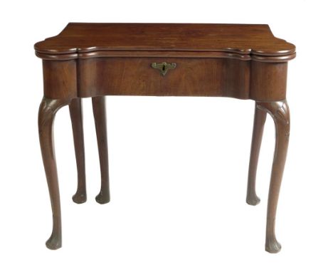  A George II Irish mahogany games table, the hinged top with protruding corners revealing a baize lined surface with candle-s