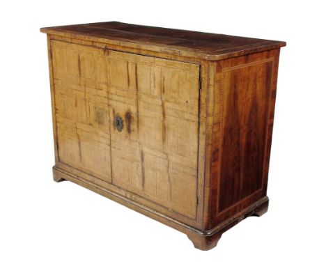  An Italian walnut cabinet, inlaid with chequer banding, with a pair of hinged doors enclosing a shelf, on bracket feet, late