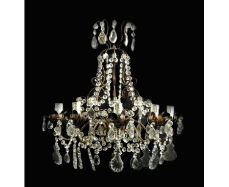  A pair of gilt metal and cut glass five light wall appliques, hung with drops and with scroll branches and petal sconces, 62