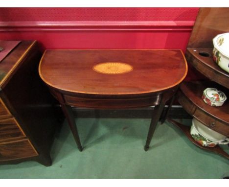 A George III shell marquetry inlaid mahogany bow front card table with crossbanded decoration, the hinged fold over top and d