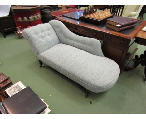 A Victorian swan back chaise long on turned legs and ceramic castors 