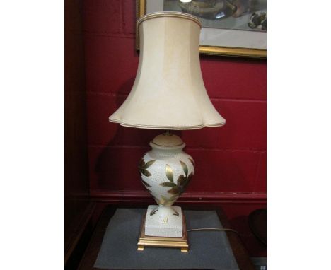 A baluster form table lamp with gilt floral decoration, with shade 
