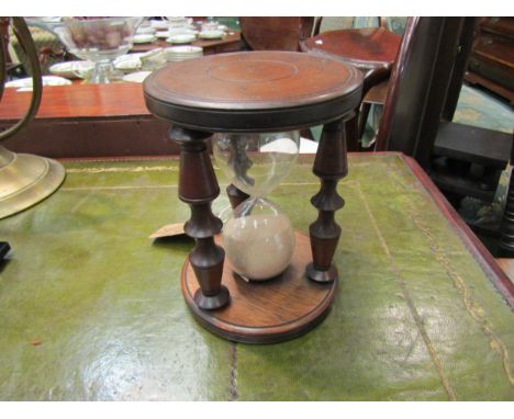 A 20th Century mahogany sailing ship half hour glass timer to mark crew watch, 18cm high 