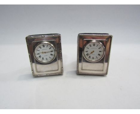 A pair of Kitney and Co. silver easel back timepieces 