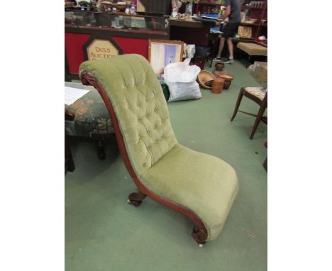 A circa 1840 button back walnut slipper chair with carved acanthus leaf decoration on white ceramic castors 