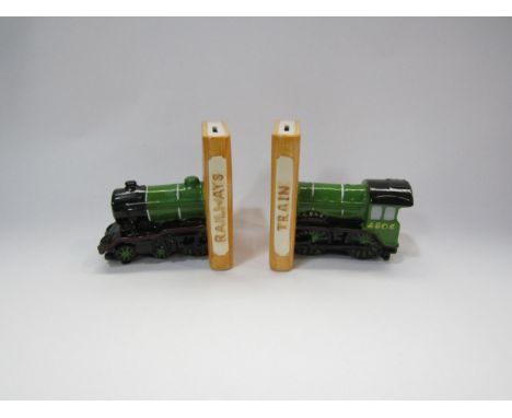 A pair of ceramic money box train bookends, 13cm tall 