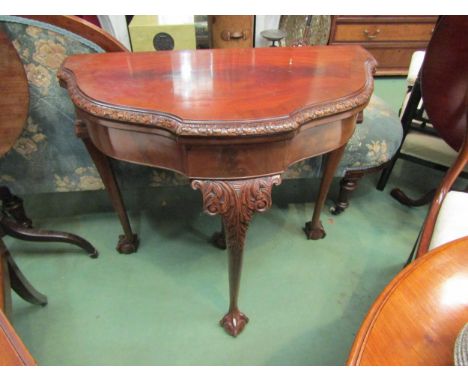 A Maple &amp; Co figured walnut card table on ball in claw cabriole leg supports 